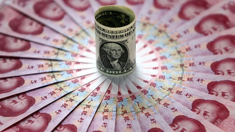 Billetes de un dólar y de 100 yuanes se exhiben en un banco el 15 de mayo de 2006 en Beijing, China. (China Photos/Getty Images)