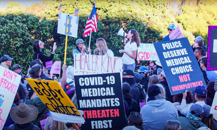 Las personas sostienen varios carteles que expresan su objeción a los mandatos de vacunación en una protesta en San Francisco, California. (Nancy Han/NTD Television)
