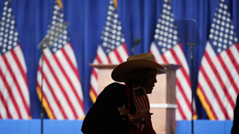 Una mujer con un stetson y una mascarilla con la bandera de Estados Unidos camina por el pasillo mientras los delegados comienzan a llegar para el primer día de la Convención Nacional Republicana en Charlotte, Carolina del Norte, el 24 de agosto de 2020. (Chris Carlson/Pool/Getty Images)