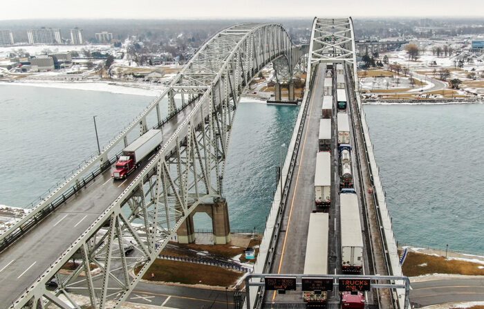 Imagen del pasado 11 de febrero de 2022 de una foto aérea hecha con un dron que muestra camiones (d) que entran en Canadá respaldados en el Puente de Agua Azul sobre el río St. Clair que une los Estados Unidos y Canadá. EFE/EPA/TANNEN MAURY