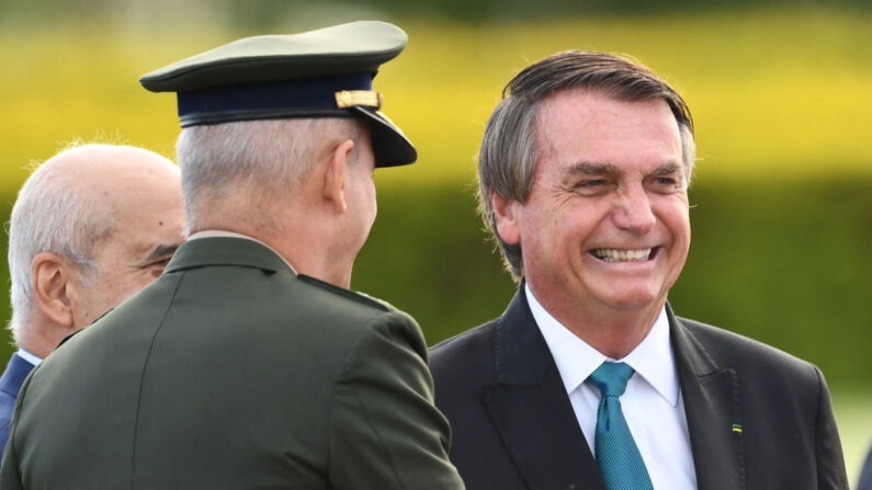 El presidente de Brasil, Jair Bolsonaro, durante una ceremonia de izamiento de bandera antes de la reunión ministerial en el Palacio de la Alvorada en Brasilia, el 17 de marzo de 2022. (EVARISTO SA/AFP vía Getty Images)