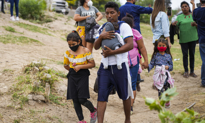 Un grupo de hondureños se prepara para cruzar el Río Bravo hacia Eagle Pass, Texas, desde Piedras Negras, México, el 21 de abril de 2022. (Charlotte Cuthbertson/The Epoch Times)
