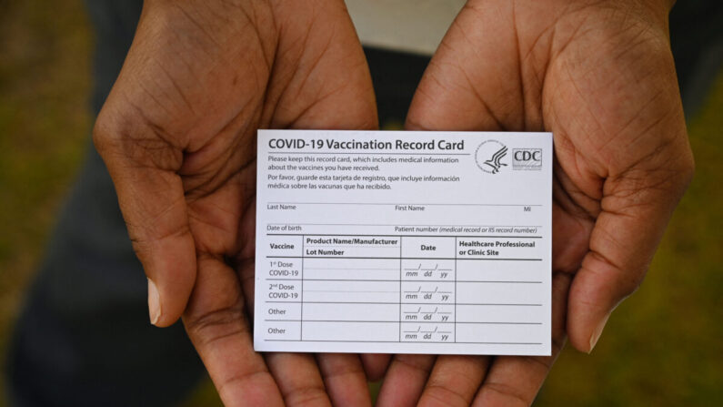 Un trabajador de la salud muestra una tarjeta de registro de vacunación COVID-19 durante una clínica de vacunas y salud en el Centro de Salud QueensCare en un barrio predominantemente latino en Los Ángeles, California, el 11 de agosto de 2021. (Robyn Beck/AFP vía Getty Images)
