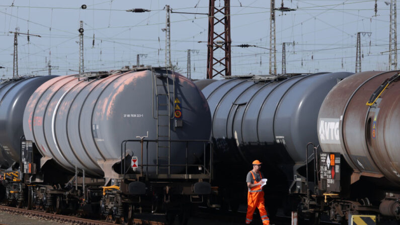 Un trabajador ferroviario camina entre vagones cisterna utilizados para el transporte de productos petrolíferos en un patio ferroviario, fuera de la refinería de petróleo TotalEnergies Leuna el 12 de abril de 2022 en Spergau, Alemania.(Sean Gallup/Getty Images)