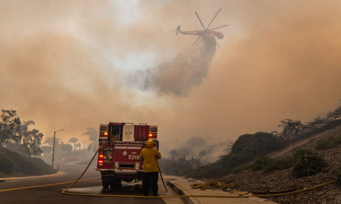 Los bomberos trabajan en la extinción del incendio oastal en Laguna Niguel, California, el 11 de mayo de 2022. (John Fredricks/The Epoch Times)