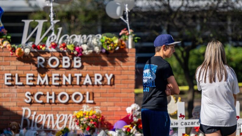 Jóvenes miran un monumento en la escuela primaria Robb después de un tiroteo masivo en Uvalde, Texas, el 26 de mayo de 2022. (Brandon Bell/Getty Images)
