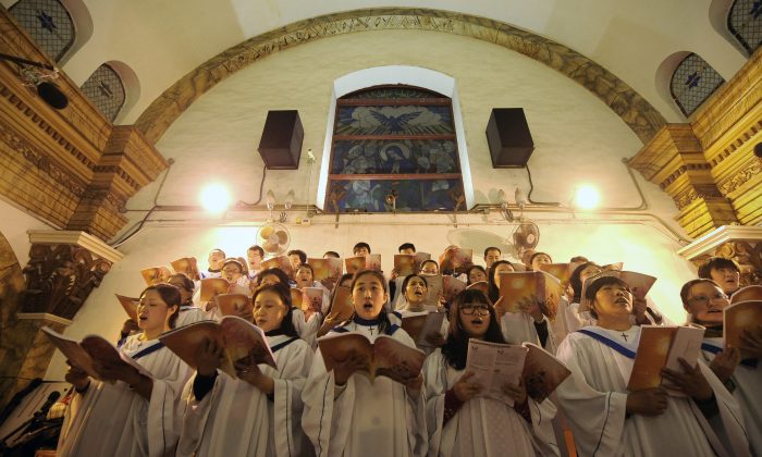 Fieles chinos cantan himnos durante la misa de Nochebuena en una iglesia católica aprobada por el Estado, en Beijing, el 25 de diciembre de 2012. (Wang Zhao/AFP/Getty Images)
