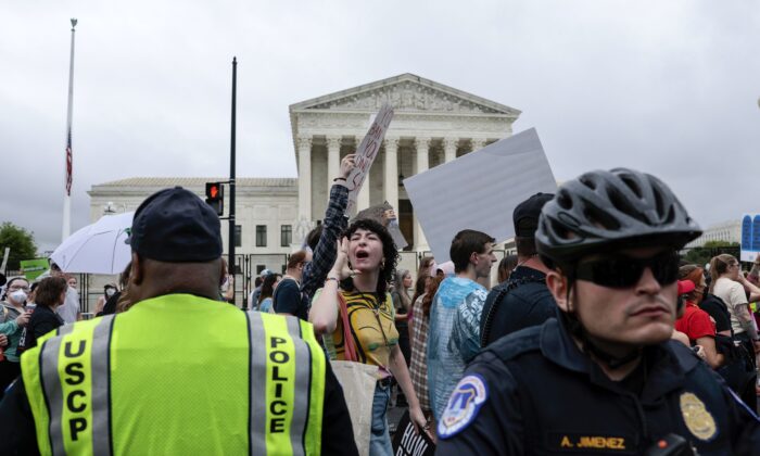 La policía vigila mientras los manifestantes pro-aborto marchan frente a la Corte Suprema de EE. UU. durante una marcha de Bans Off Our Bodies en Washington, el 14 de mayo de 2022. (Anna Moneymaker/Getty Images)