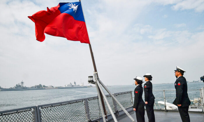 Marineros taiwaneses saludan la bandera de la isla, en la cubierta del buque de abastecimiento Panshih, después de participar en simulacros anuales, en la base naval de Tsoying, en Kaohsiung, el 31 de enero de 2018. (Mandy Cheng/AFP vía Getty Images)