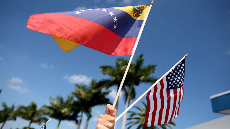 Una persona sostiene una bandera venezolana y estadounidense el 1 de marzo de 2014 en Miami, Florida. (Joe Raedle/Getty Images)