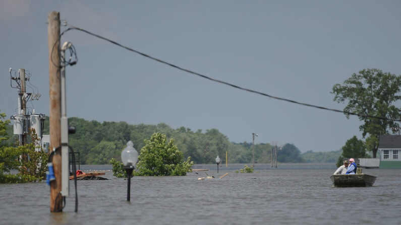 En una fotografía de archivo, una pareja sube en bote mientras las aguas de la inundación suben el 7 de junio de 2019 en Grafton, Illinois (EE.UU.). (Michael B. Thomas/Getty Images)