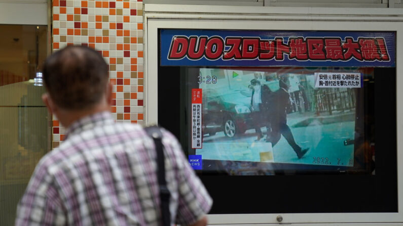 Un hombre mira una pantalla que transmite la noticia de que el ex primer ministro de Japón, Shinzo Abe, ha recibido disparos mientras hacía campaña en Nara, el 08 de julio de 2022 en Tokio, Japón. (Christopher Jue/Getty Images)