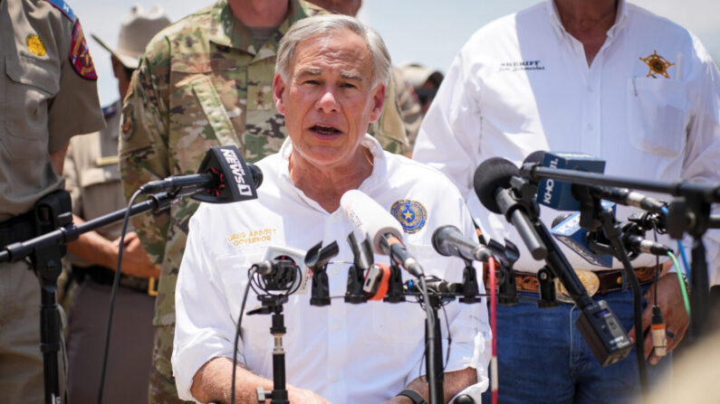 El gobernador de Texas, Greg Abbott, rodeado de oficiales estatales y locales, habla con los medios de comunicación en Eagle Pass, Texas, el 29 de junio de 2022. (Charlotte Cuthbertson/The Epoch Times)
