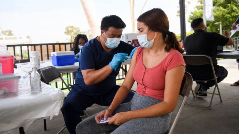 Una estudiante universitaria recibe la vacuna COVID-19 en la California State University Long Beach en Long Beach, California, el 11 de agosto de 2021. (Patrick T. Fallon/AFP vía Getty Images)
