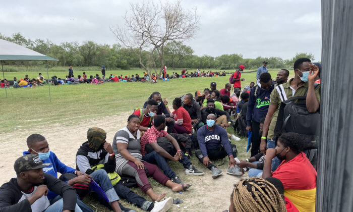 Un grupo de más de 350 inmigrantes ilegales espera a la Patrulla Fronteriza después de cruzar el Río Grande desde México hacia Del Río, Texas, el 25 de julio de 2021. (Charlotte Cuthbertson/The Epoch Times)