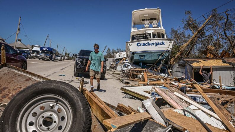 Unas personas limpian los escombros tras el paso del huracán Ian por Fort Myers Beach, Florida, el 30 de septiembre de 2022. (Giorgio Viera/AFP vía Getty Images)