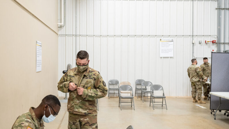 El sargento de Primera Clase de los Servicios de Medicina Preventiva Demetrius Roberson se prepara para administrar una vacuna COVID-19 a un soldado el 9 de septiembre de 2021 en Fort Knox, Kentucky. (Jon Cherry/Getty Images)
