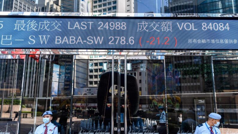 Actividad bursátil de Alibaba Group Holding Ltd. (BABA-SW). (BABA-SW) (arriba C) se muestra por encima de los guardias de seguridad mientras están fuera de las torres de Exchange Square en Hong Kong el 4 de noviembre de 2020. (Anthony Wallace/AFP vía Getty Images)
