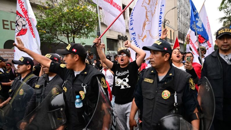 Varias personas participan en una marcha para pedir la paz y en apoyo de la policía y el ejército en Lima (Perú), el 16 de diciembre de 2022. (Martin Bernetti/AFP vía Getty Images)