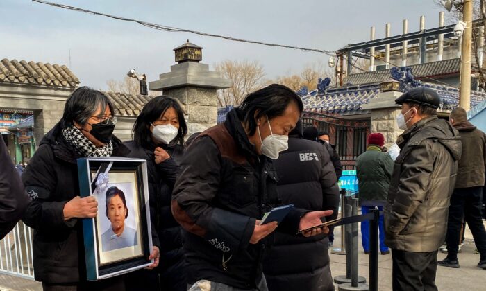 Los familiares llevan un marco de foto de un ser querido en un crematorio en Beijing, el 20 de diciembre de 2022. (Noel Celis/AFP a través de Getty Images)