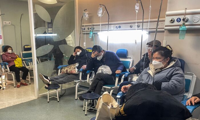 Las personas reciben atención médica en el área de una clínica de fiebre en un hospital en el distrito de Changning en Shanghai el 23 de diciembre de 2022 - China está luchando contra una ola de infecciones por coronavirus que ha golpeado duramente a los ancianos pero resultó en solo un pequeño número de muertes reportadas después de que Beijing redefinió los criterios por los cuales se cuentan las muertes por COVID. (Héctor Retamal/AFP vía Getty Images)
