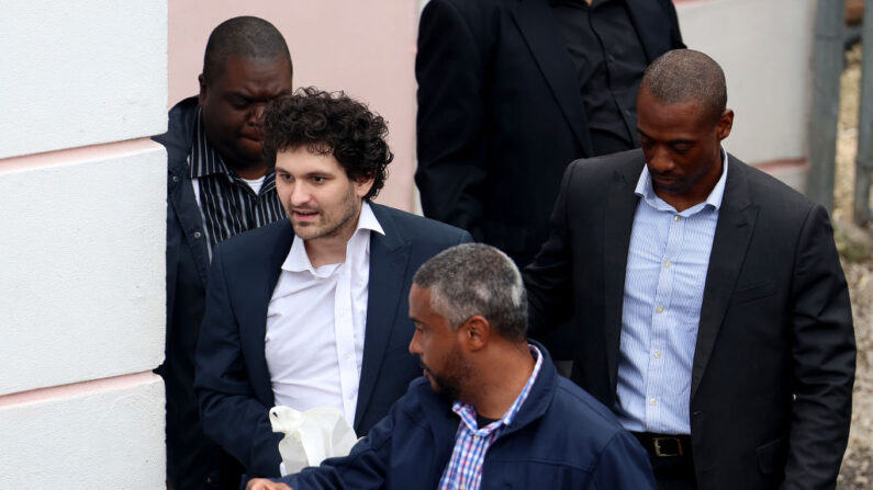 El cofundador de FTX, Sam Bankman-Fried, es escoltado fuera del Tribunal de Magistrados el 21 de diciembre de 2022 en Nassau, Bahamas, antes de ser extraditado a EE.UU. (Joe Raedle/Getty Images)