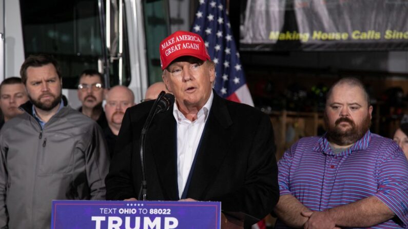 El senador estadounidense JD Vance (R-OH) (izq.) y el alcalde de East Palestine, Trent Conaway (der.), observan al expresidente estadounidense Donald Trump mientras habla en el Departamento de Bomberos de East Palestine, en Ohio, el 22 de febrero de 2023. (REBECCA DROKE/AFP vía Getty Images)