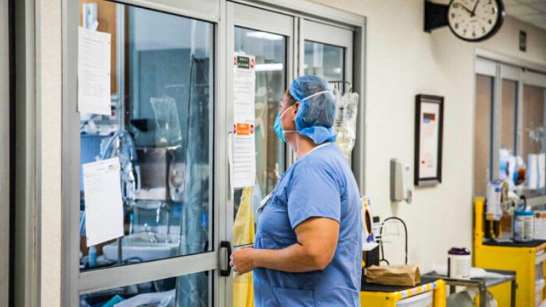 Profesional sanitario se prepara para entrar en la habitación de un paciente de COVID-19 en una foto de archivo. (Megan Jelinger/AFP vía Getty Images)