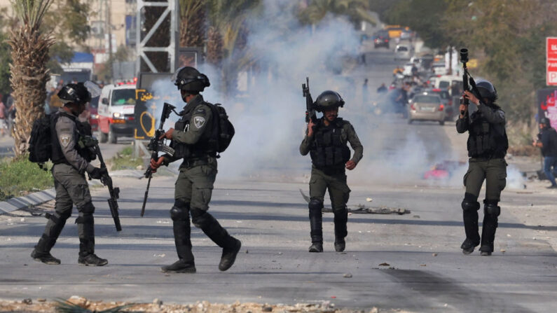 Fuerzas de seguridad israelíes se enfrentan a jóvenes palestinos durante una redada militar en la ciudad de Jericó, en Cisjordania ocupada, el 1 de marzo de 2023. (Ahmad Gharabli/AFP vía Getty Images)