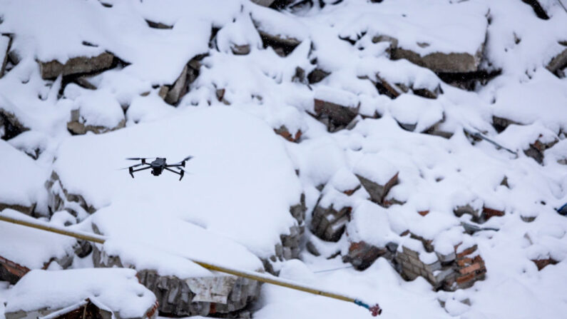 Un dron DJI Mavic 3 controlado por un operador de drones de la 93ª Brigada del Ejército Ucraniano vuela sobre escombros cubiertos de nieve cerca de la línea del frente con las tropas rusas el 18 de febrero de 2023 en Bakhmut, Ucrania. (John Moore/Getty Images)