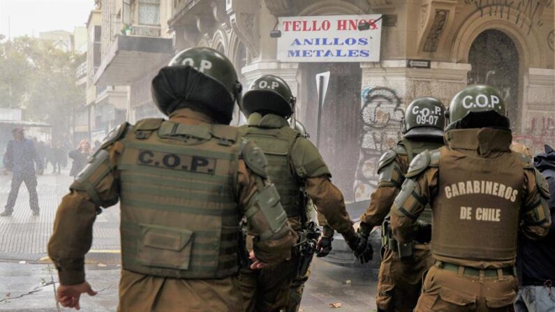 Un grupo de carabineros se enfrentan a unos manifestantes el 12 de abril de 2023, en el centro de Santiago de Chile (Chile). EFE/ Javier Martín