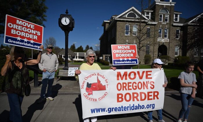 Varias personas sostienen carteles a favor del movimiento Greater Idaho en Enterprise, Oregón, el 12 de mayo de 2023. (Robyn Beck/AFP vía Getty Images)