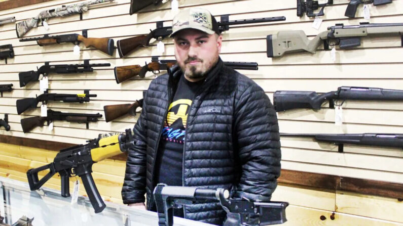Justin Barrett, propietario de Barrett Outdoors en Durant, Okla., muestra algunas abrazaderas estabilizadoras de pistola. (Michael Clements/The Epoch Times)
