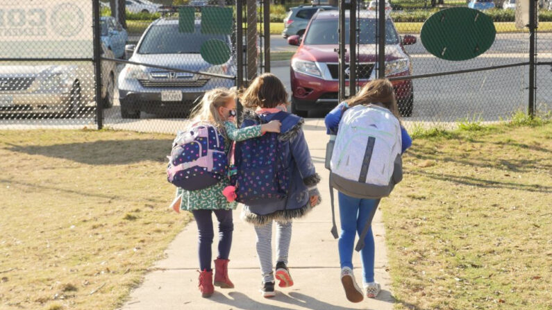 Escolares caminan por el exterior de una escuela, a las afueras de Houston, Texas (EE.UU.), el 16 de diciembre de 2020. (François Picard/AFP vía Getty Images)