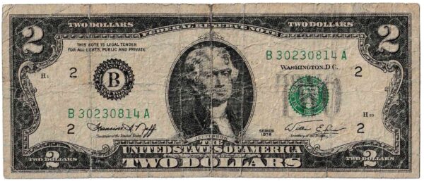 Un billete de $2 de la serie de 1976 muy desgastado, quizá el más común de encontrar hoy en día. (Dominio público)