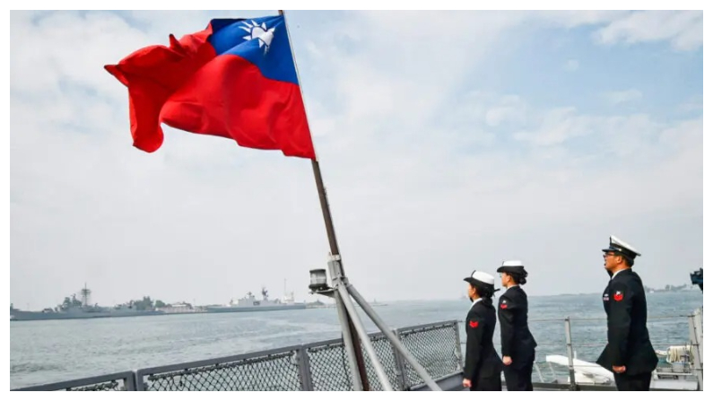 Marineros taiwaneses saludan la bandera de la isla en la cubierta del buque de aprovisionamiento Panshih tras participar en los ejercicios anuales en la base naval de Tsoying, en Kaohsiung, Taiwán, el 31 de enero de 2018. (Mandy Cheng/AFP vía Getty Images)