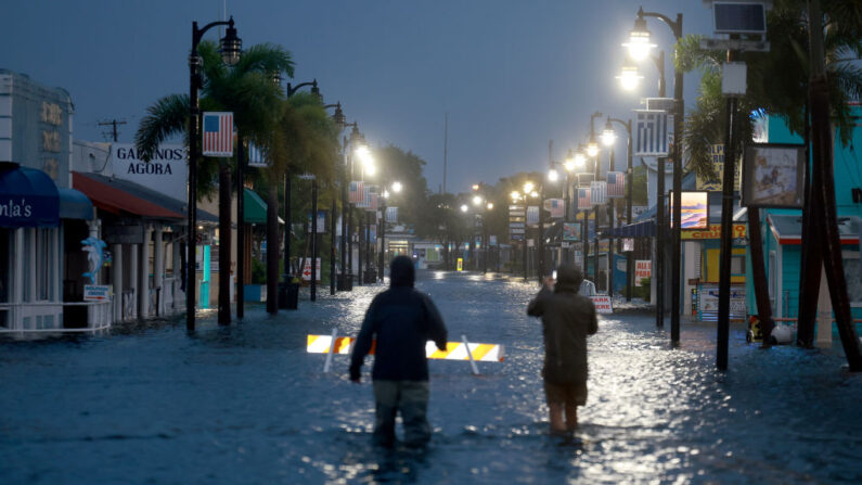 Los reporteros caminan a través de las aguas de Tarpon Springs, Florida, horas antes de que el huracán Idalia toque tierra en Big Bend en Florida. (Joe Raedle/Getty Images)inundación del centro de la ciudad 