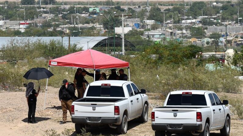 Personal de la fiscalía del estado vigilan la zona en que fue hallada una fosa clandestina en la fronteriza Ciudad Juárez, México, 8 de septiembre. (EFE/Luis Torres)