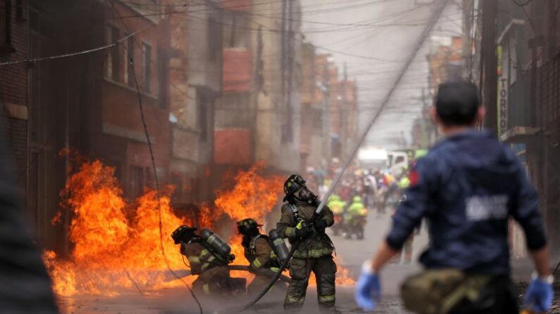 Bomberos combaten un incendio provocado por una explosión en Colombia, el 18 de febrero de 2021. (Andres Castro/AFP vía Getty Images)