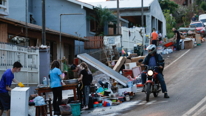 Residentes limpian sus muebles cubiertos de barro en la calle fuera de su casa que fueron dañados por las inundaciones causadas por un ciclón tropical el 6 de septiembre de 2023 en Colinas, Brasil. (Marcelo Oliveira/Getty Images)