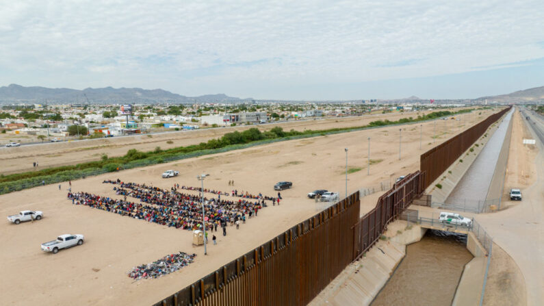En una vista aérea, se ve a migrantes agrupados mientras esperan a ser procesados en el lado de la frontera de Ciudad Juárez el 21 de septiembre de 2023 en El Paso, Texas. (Brandon Bell/Getty Images)