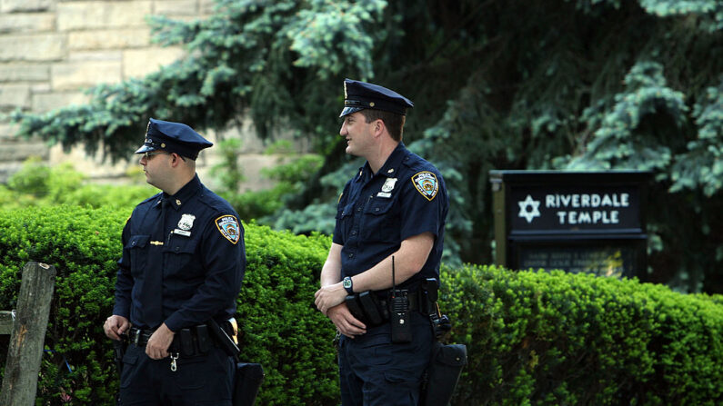 La policía monta guardia ante el templo de Riverdale tras el aparente desmantelamiento de un complot terrorista en el distrito neoyorquino del Bronx el 21 de mayo de 2009. Cuatro sospechosos fueron detenidos acusados de planear la detonación de explosivos cerca de una sinagoga y un centro judío en el barrio neoyorquino del Bronx y el derribo de aviones militares situados en la base de la Guardia Nacional Aérea de Nueva York en el aeropuerto Stewart de Newburgh (Nueva York), después de que una operación policial y del FBI de un año de duración proporcionara a los sospechosos explosivos y un misil inactivo. (Spencer Platt/Getty Images)