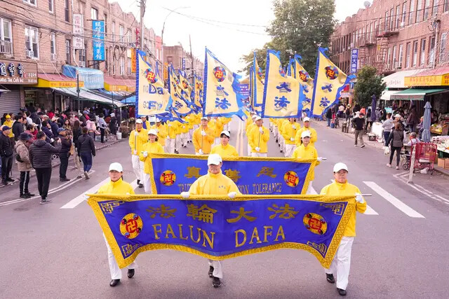 Practicantes de Falun Dafa caminan en un desfile que expone la persecución a su fe por parte del régimen chino, en Brooklyn, Nueva York, el 15 de octubre de 2023. (Larry Dye/The Epoch Times)
