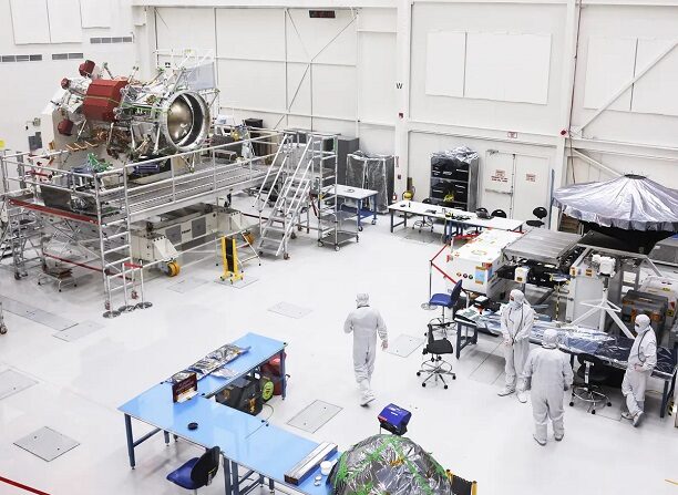 Trabajadores de la Administración Nacional de la Aeronáutica y del Espacio (NASA) se reúnen cerca de un componente de propulsión (L) para la nave espacial Europa Clipper mientras se prepara dentro de una sala limpia de la Instalación de Ensamblaje de Naves Espaciales en el Laboratorio de Propulsión a Chorro (JPL) de la NASA en Pasadena, California, el 11 de abril de 2023. (Mario Tama/Getty Images)