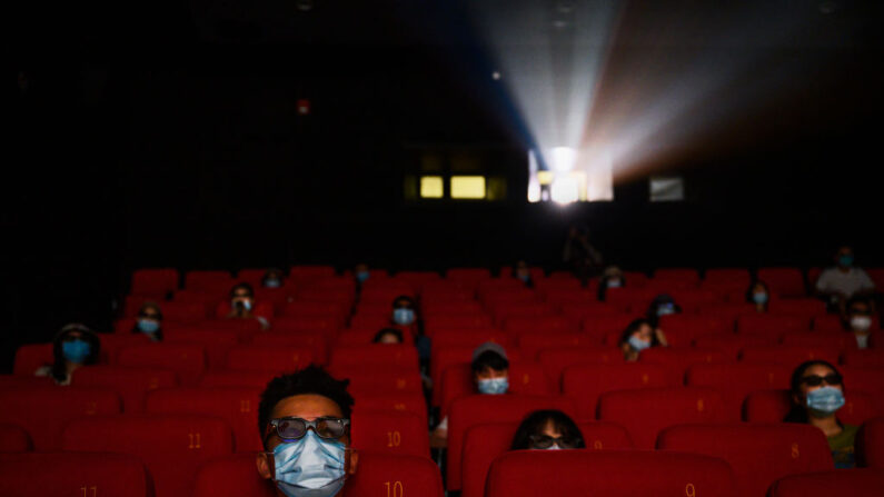 Varias personas llevan mascarillas mientras ven una película en 3D en un cine en Beijing, el primer día que se permitió su estreno, el 24 de julio de 2020. (Kevin Frayer/Getty Images)