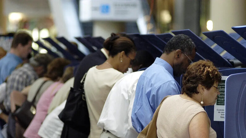 Votantes hispanos acuden a las urnas para la votación anticipada en el Centro Gubernamental de Miami-Dade en Miami, Florida, el 21 de octubre de 2004. (G. De Cardenas/Getty Images)