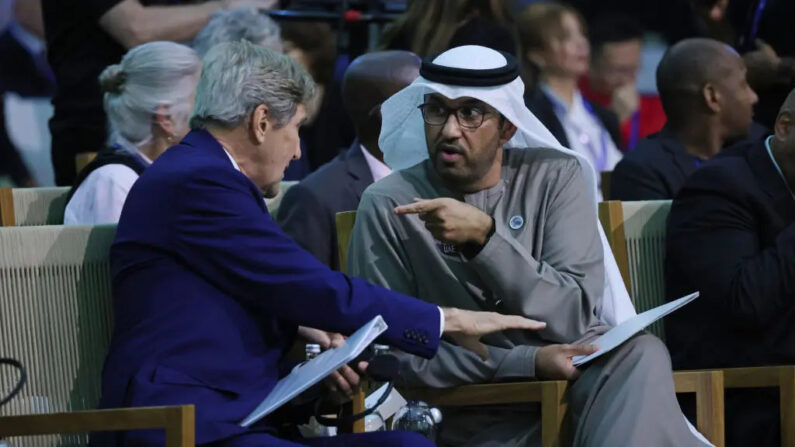 John Kerry (L), U.S. special presidential envoy for climate, and Sultan Ahmed Al Jaber, president of the COP28 UNFCCC Climate Conference, speak to each other during Day 2 of the high-level segment of the UNFCCC COP28 Climate Conference in Dubai, United Arab Emirates, on Dec. 2, 2023. (Sean Gallup/Getty Images)
