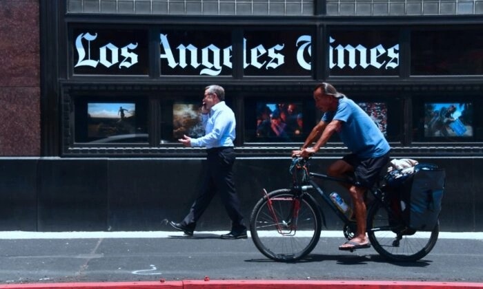 La gente pasa por el edificio de oficinas de Los Angeles Times en el centro de Los Ángeles el 16 de julio de 2018. (Frederic J. Brown/AFP vía Getty Images)
