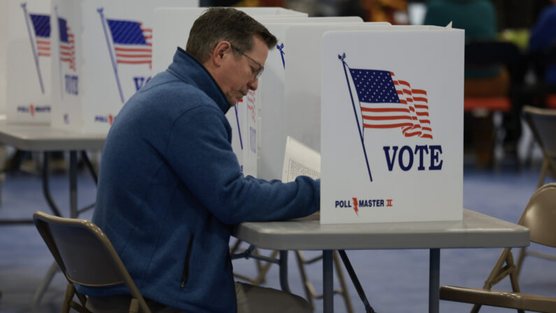 BEDFORD, NEW HAMPSHIRE - JANUARY 23: A voter fills out their ballot at a polling location at Bedford High School on January 23, 2024 in Bedford, New Hampshire. Voters headed to the polls as New Hampshire holds its primary. (Photo by Joe Raedle/Getty Images)