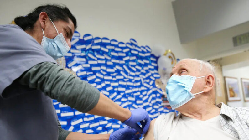 Un asistente médico certificado aplica una tirita después de administrar una vacuna en el Centro Médico Harbor-UCLA en Torrance, California, el 21 de enero de 2021. (Mario Tama/Getty Images)